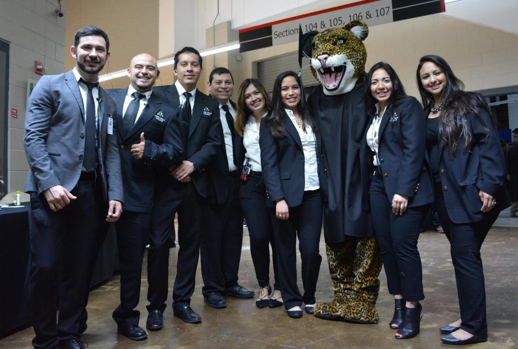 Staff members posing with Jerry the Jaguar